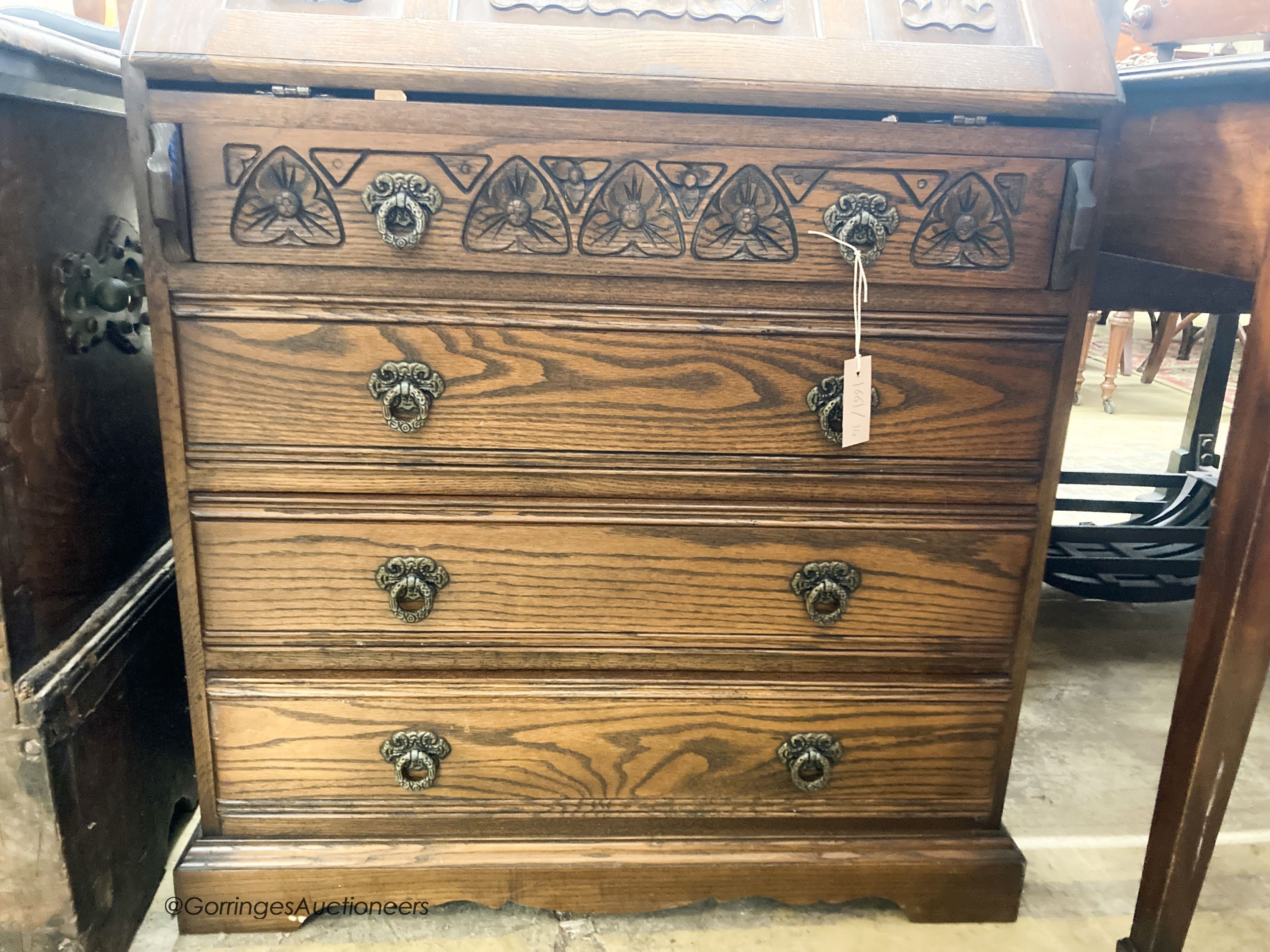 A reproduction oak linenfold carved bureau, W.75cm D.48cm H.99cm